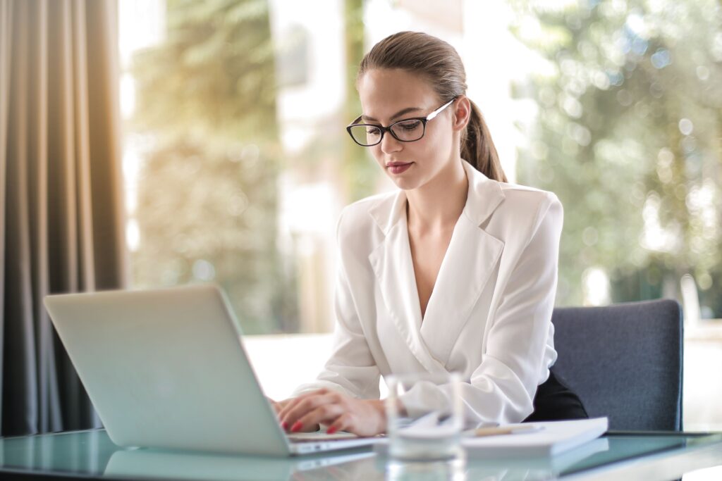 Contributor writing an article on a laptop at a desk